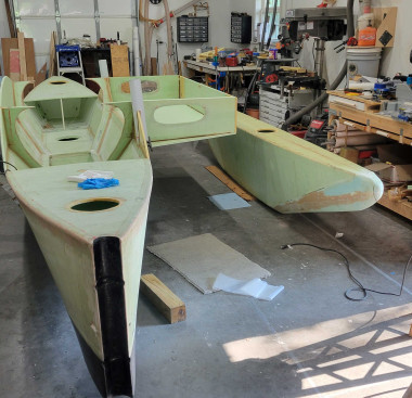 Assembly continues. Hull now in a cradle with rollers so boat can be moved around a bit. 